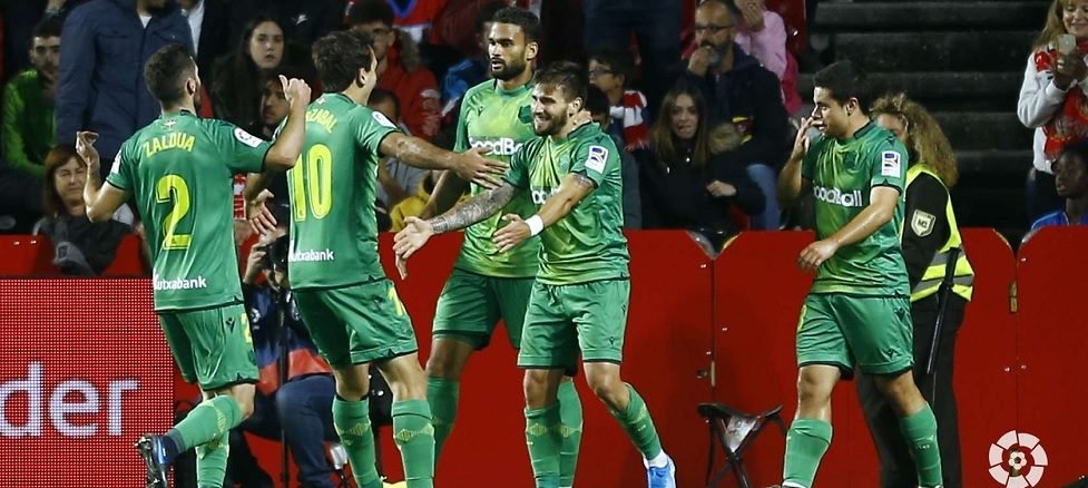 Portu celebrates his second goal with Real Sociedad players.